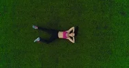Sports Woman Resting After Workout Lying On Grass. Top View. Frame From Height Stock Footage