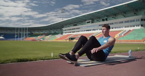 Sportsman doing abs exercise on stadium Stock Footage 199646090