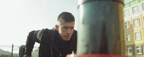 Sportsman Doing Dips on Parallel Bars Outdoor Stock Footage 166434972