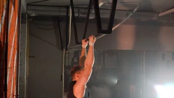 Sportsman doing an exercise on a horizontal bar in the gym Stock Footage 86080589