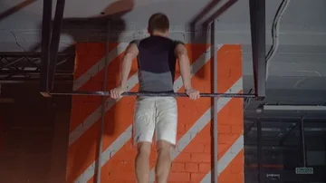 Sportsman doing an exercise on a horizontal bar in the gym Stock Footage 86080876