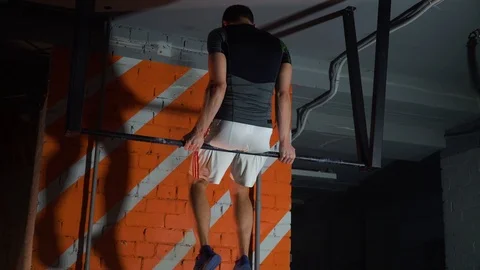 Sportsman doing an exercise on a horizontal bar in the gym Stock Footage 86081147