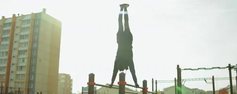 Sportsman Doing Handstand on Parallel Bars at Workout Playground Stock Footage 166434189