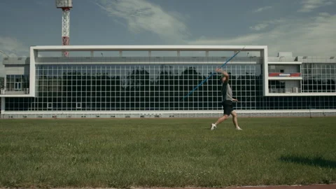 Sportsman with Limb Difference Throwing Javelin at Athletics Field Video stock 297959609