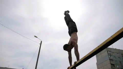 Sportsman performing dynamic workout on parallel bars, showcasing strength Stock Footage 317234732