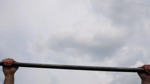 Sportsman performing intense pull-up workout, showcasing muscular strength and Stock Footage 329753960
