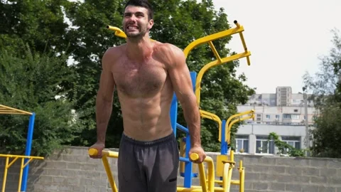 Sportsman performing intense workout on parallel bars, showcasing strength Stock Footage 321054003