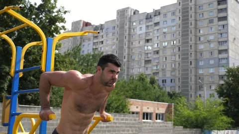 Sportsman performing intense workout on parallel bars, showcasing strength and Video stock 329757768