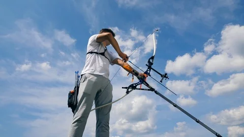Sportsman pulling an arrow in a bow on a range. Stock Footage 114968754