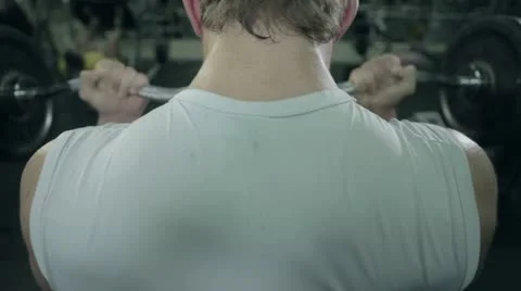 Sportsman swings muscles in the gym barbell Stock Footage