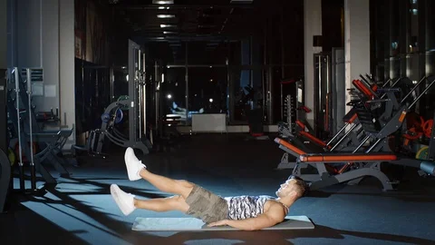 Sportsman working on core strength doing scissor kick and flutter kick Stock Footage