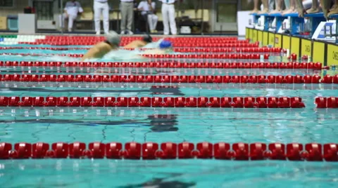 Sportsmen in relay, some finish breaststroke, others start on open championship Stock Footage