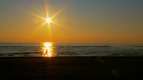 Sportsmen training on the beach at sunset Stock Footage