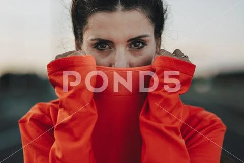 Sportswoman covering her face with tracksuit Stock Photos