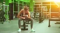 The sportswoman doing exercise with dumbbells in the gym 4k or 4k+ Resolution