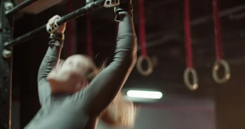 Sportswoman doing pull ups on bar at gym Stock Footage 272369005