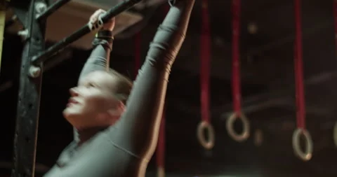 Sportswoman doing pull ups on bar at gym Video stock 272372492