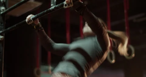 Sportswoman doing pull ups on bar at gym Stock Footage 272372686