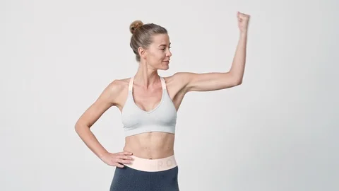 Sportswoman Flexing Biceps To Camera 스톡 동영상 116752691