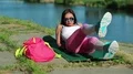 Sportswoman lies on green mat near the lake and train abdominal muscles HD Footage