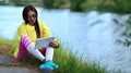Sportswoman sits near lake and works with tablet computer HD Footage