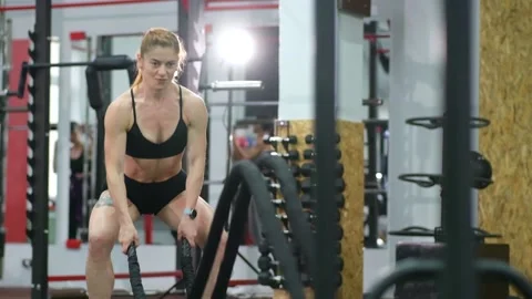 Sportswoman working out in functional training gym doing exercise with battle Video stock 155273557