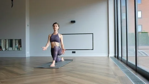 Sporty beautiful woman practicing yoga indoors. meditation relaxation silence Stock Footage