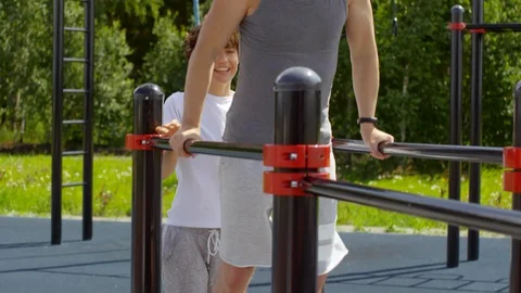 Sporty Couple Practicing Parallel Bars Hand Walk Stock Footage 97638028