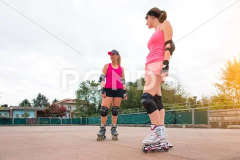 Sporty girls in golf rollerblade Stock Photos