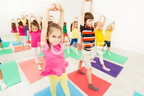 Sporty kids stretching during gymnastic activity Stock Photos
