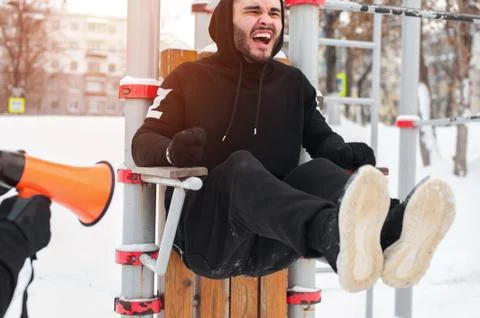 Sporty man exercising on parallel bars with coach Stock Photos
