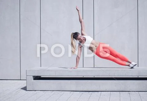 Sporty Woman Doing Side Plank Exercise on Platform Stock Photos
