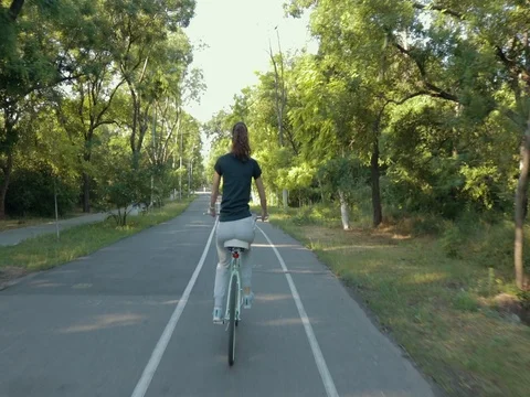 Sporty woman riding a bicycle in the park Stock Footage
