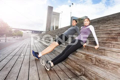 Sporty young couple exercising together outdoors Stock Photos