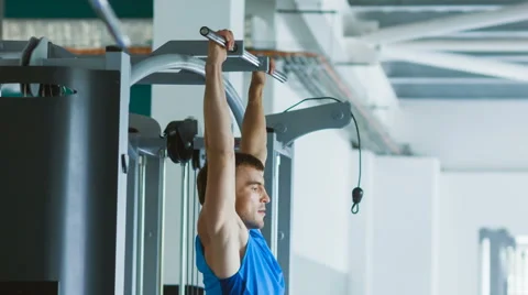 Sporty young man doing exercise at the gym Stock Footage 64794363
