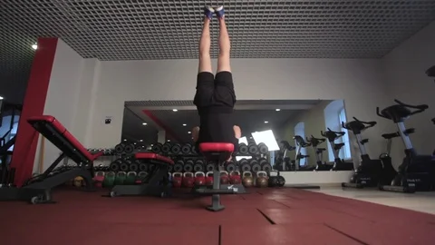 Sporty young man practicing abdominal, rock press exercise, working out Stock Footage 73169179