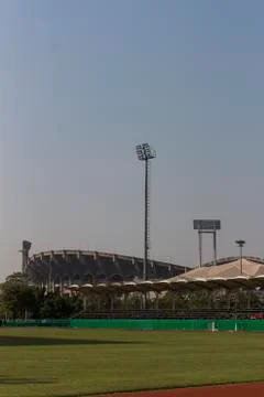 Spot light pole in a stadium against blue sky; Stock Photos