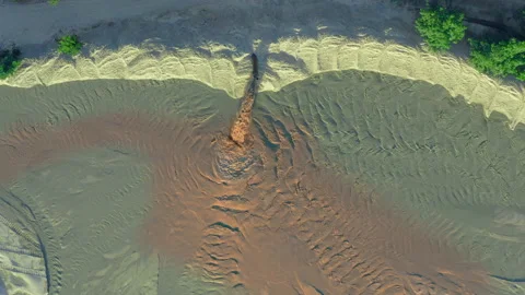 Spot rusty contamination from liquid flowing out of pipe, aerial drone shot Stock Footage 167483989