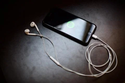 Spotify logo is on the smartphone screen. Smartpho Stock Photos