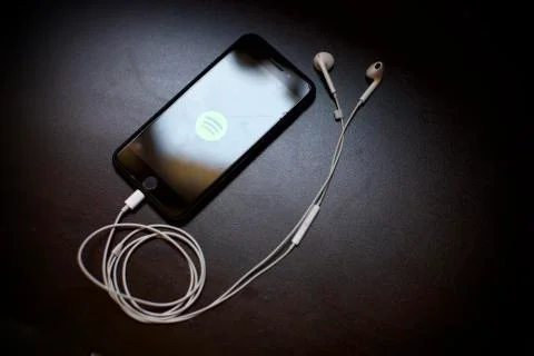Spotify logo is on the smartphone screen. Smartpho Fotos Stock