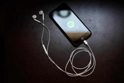 Spotify logo is on the smartphone screen. Smartpho Stock Photos