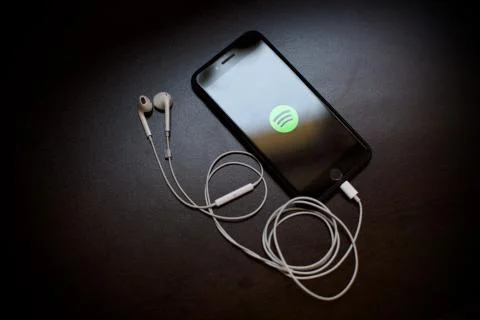 Spotify logo is on the smartphone screen. Smartpho Stock Photos
