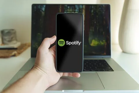 Spotify music streaming application logo in front of laptop. High quality photo. Stock Photos