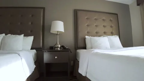 A spotless clean hotel room with sunlight penetrating through window Stock Footage 154592686