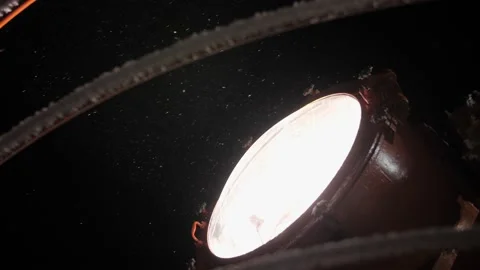 Spotlight of a large ship in the night and snowfall Video stock 139875989