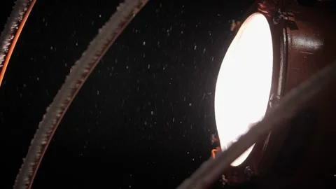Spotlight of a large ship in the night and snowfall Video stock 141643397