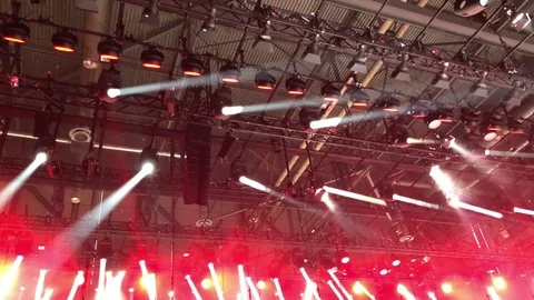 Spotlight performance in red color light truss structure in exhibition hall Stock Footage 86986423