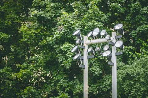 Spotlight on a pole against the forest background Stock Photos