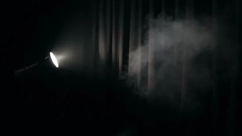 Spotlight projecting beam of light through smoke, Bright studio spotlight Stock Footage 301317650