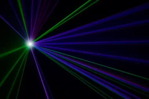 Spotlight shining on a black background Stock Photos